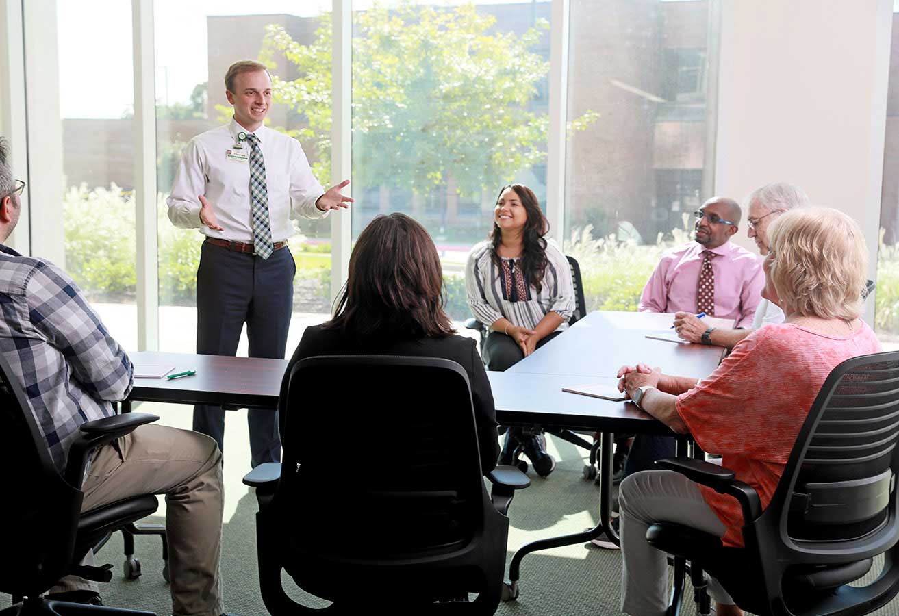 A Lexington Health representative speaking with members of the community.
