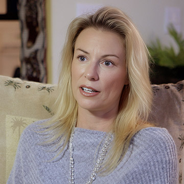 Jina Moore sitting on a couch.