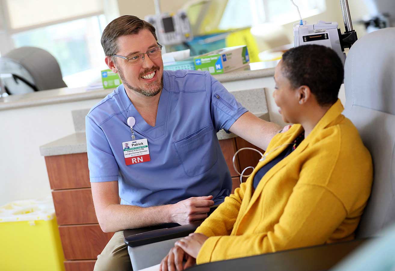 A registered nurse smiling with a patient.